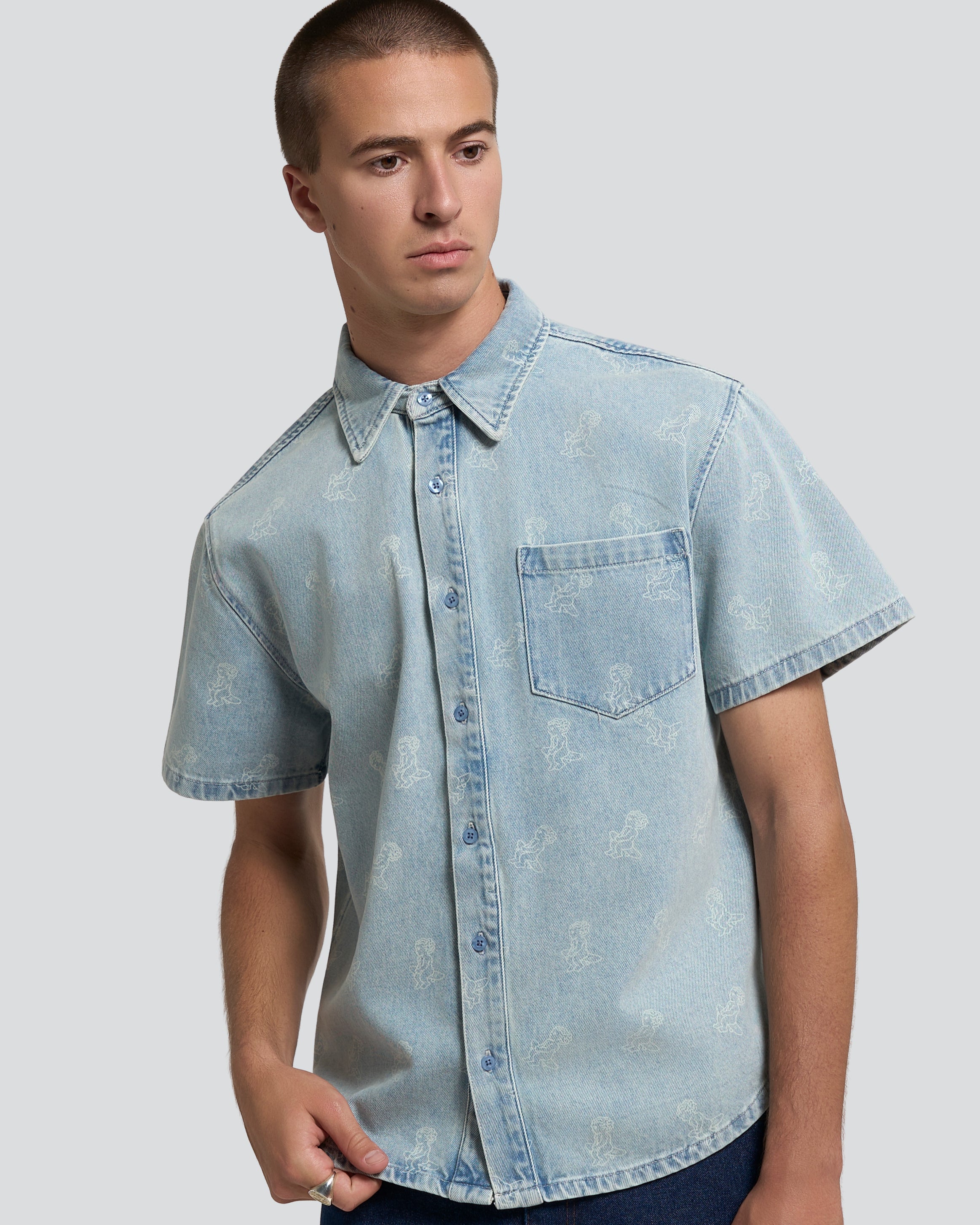 Light blue denim with all-over Ikon logo
Pair with the matching Emodi Kit Shorts for a complete look
Made from 100% cotton for a soft, breathable feel
Short-sleeved construction with a single chest pocket
Button front closure with tonal stitching
Slightly dropped shoulders for a relaxed silhouette
Unisex design
Cold wash only