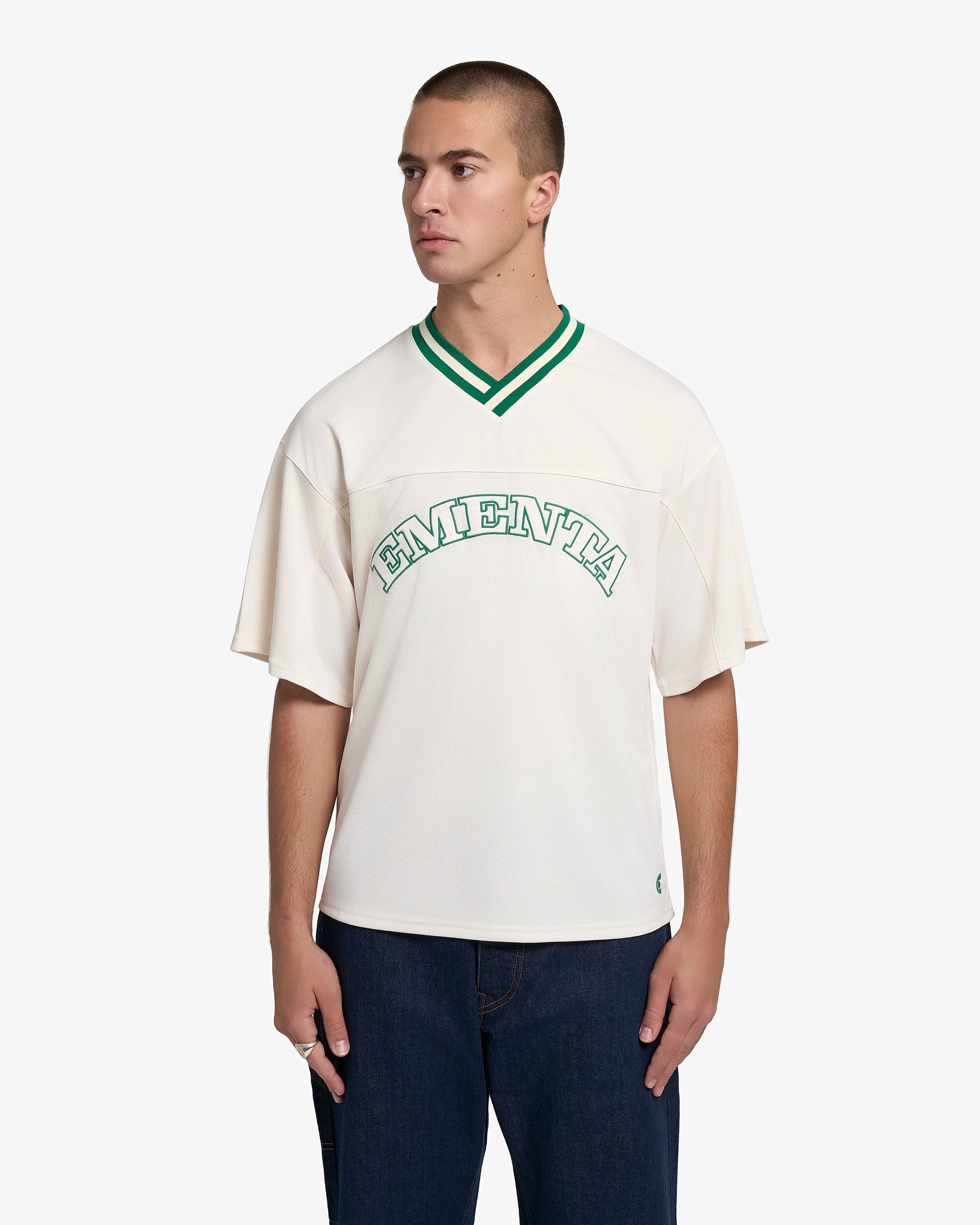 Breathable mesh fabric on the lower half, cotton-poly blend on the upper half
Oversized fit
White color with green accents
Large 'EMENTA' embroidery on the chest, small branded detail embroidered on the bottom right
V-neck collar with double green stripes
Oversized sleeves for a relaxed silhouette
Part of a kit – matching shorts available online
Machine washable
