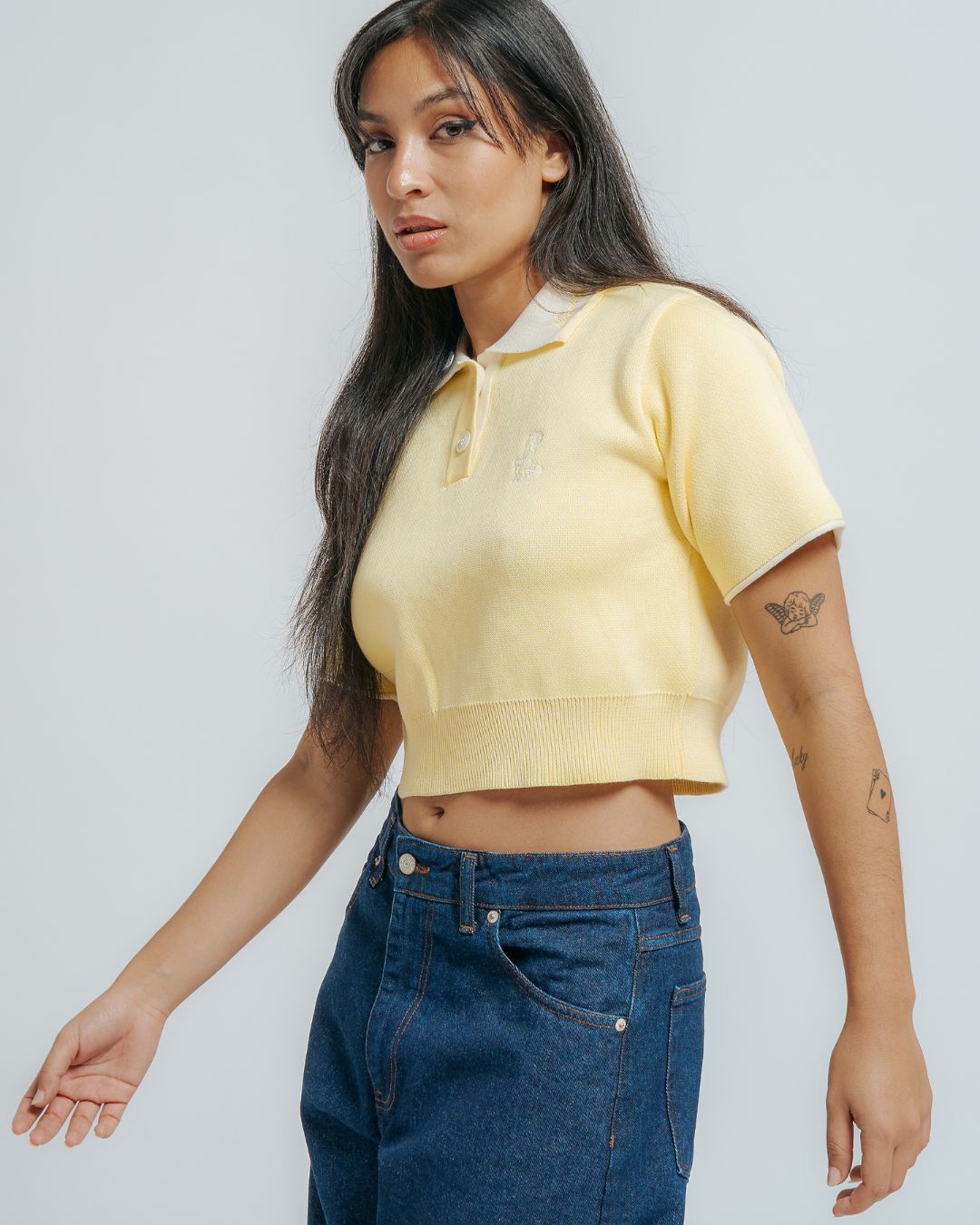 100% cotton knit
Butter colored fabric with off white contrasting details&nbsp;
Women's cropped fit
Classic polo collar in off white color&nbsp;
Two-button placket with matching cream buttons
Short sleeves with off white cuff trim&nbsp;
Ribbed hem for a clean finish&nbsp;
"Moved By Friendship" embroidery on the collar&nbsp;
Ikon logo embroidery on the left chest
Constructed from a soft knit fabric for a comfortable feel

Designed with a fitted silhouette that flatters the figure without being too tight
Brea