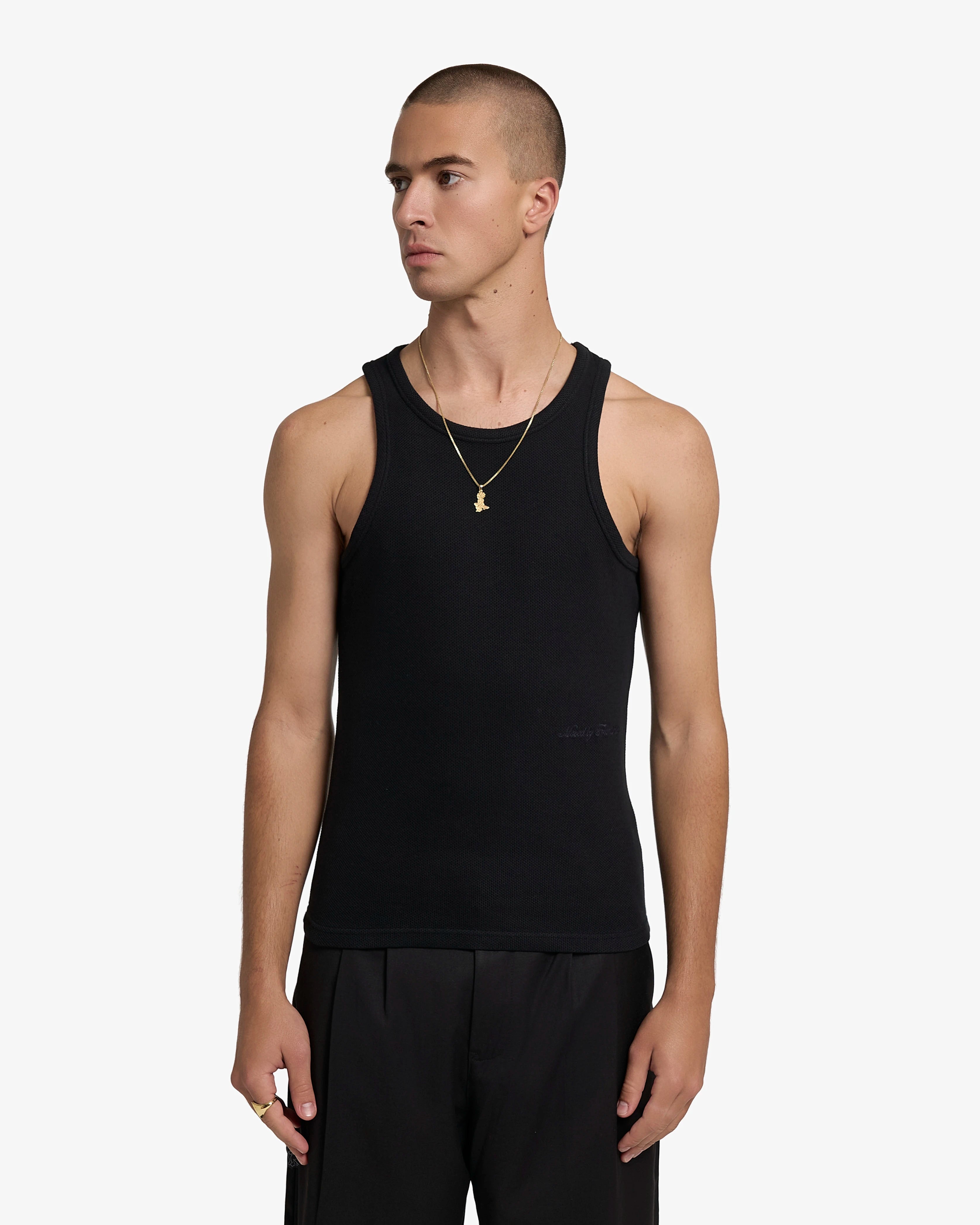 Sleeveless tank top designed with a close and elongated silhouette
Textured cotton waffle fabric with a soft and breathable feel
Slim fit with wide shoulder straps and a high-cut neckline
Tonal “Moved By Friendship” embroidery placed at the lower front
Black base with minimal tonal detailing
Machine wash cold. Do not tumble dry
Made in Portugal