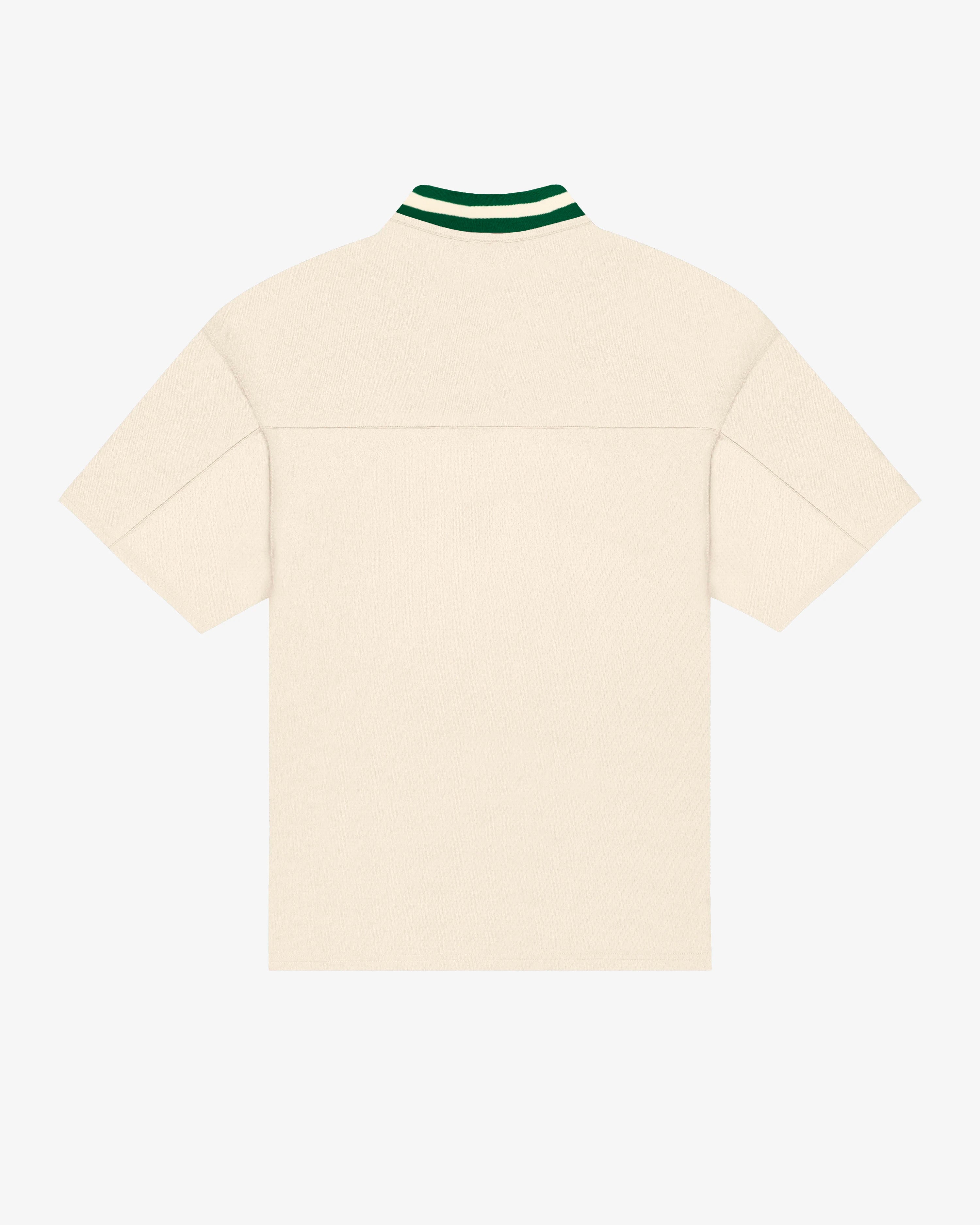 Breathable mesh fabric on the lower half, cotton-poly blend on the upper half
Oversized fit
White color with green accents
Large 'EMENTA' embroidery on the chest, small branded detail embroidered on the bottom right
V-neck collar with double green stripes
Oversized sleeves for a relaxed silhouette
Part of a kit – matching shorts available online
Machine washable