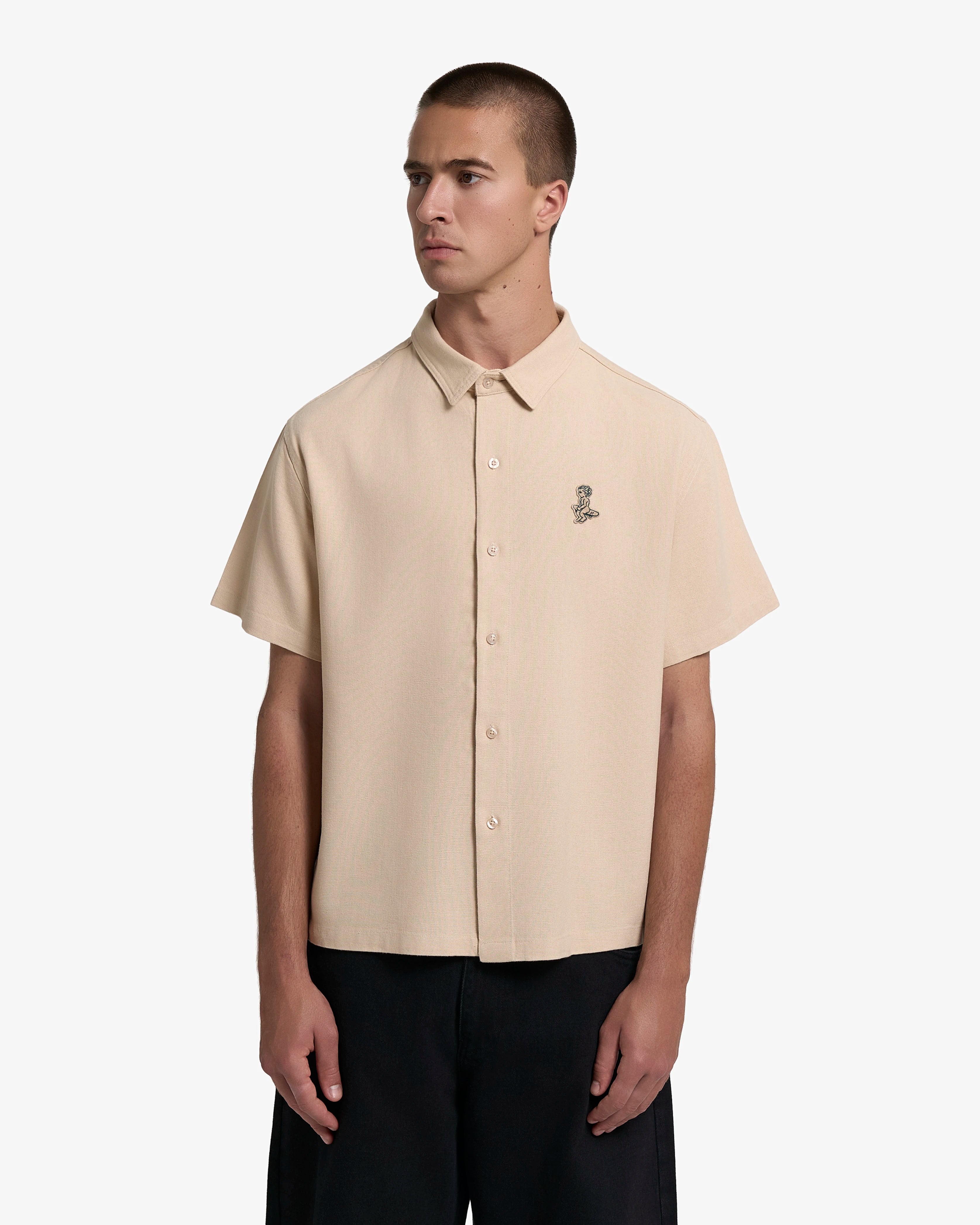 Short sleeve button-up shirt with a clean, structured appearance
100% cotton fabric with a textured weave and dry hand feel
Relaxed fit with a straight cut for ease of movement
Chest embroidered patch featuring the Ikon logo
Beige tone with tonal buttons